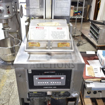 Henny Penny PFG-690 Computron 8000 pressure fryer, natural gas, 100,000 BTU, on casters, with control panel and safety labels.