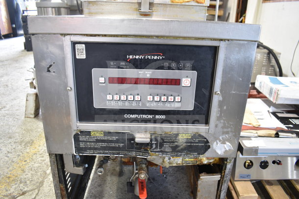 Henny Penny PFG-690 Computron 8000 pressure fryer, commercial model on casters, showing front controls and caution label.