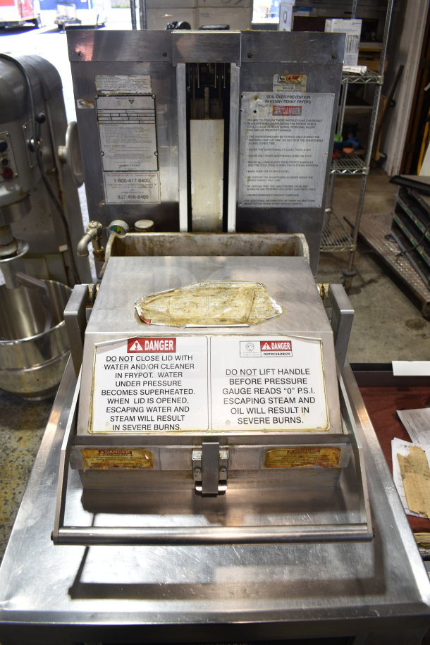 Henny Penny PFG-690 Computron 8000 pressure fryer on casters, natural gas, 100,000 BTU, visible safety warnings.