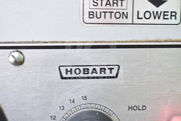 Hobart M-802 mixer control panel with logo and speed dial. Markings indicate "START BUTTON" and "LOWER."