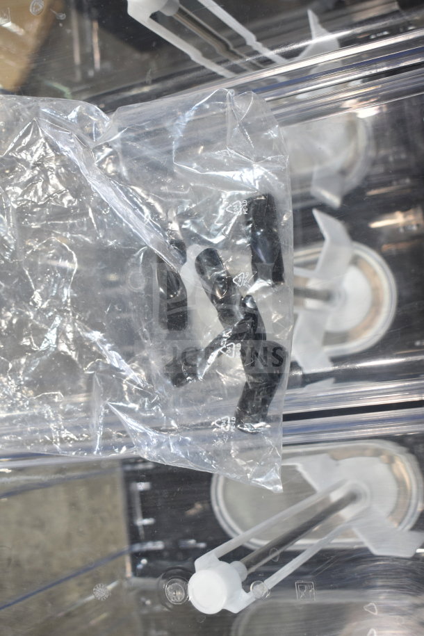Brand new Vollrath VBBE3-37-S beverage dispenser with components in plastic bag, showcasing stirring paddles.