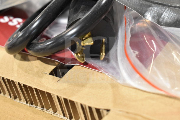 Close-up of a power plug for a 2024 Estella 236HWDD5D MT25 commercial hot water dispenser on cardboard packaging.