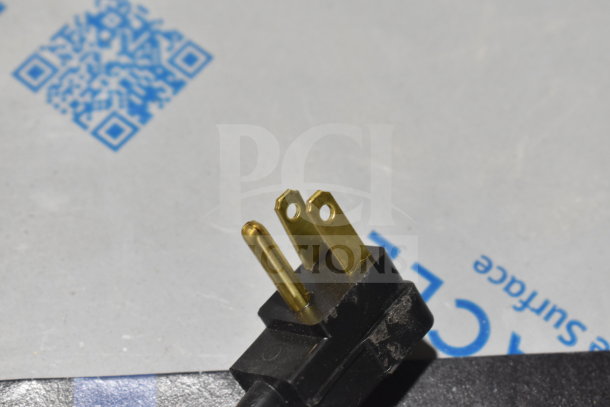 Close-up image of a three-prong plug for the Beverage Air UCFD27AHC-2 freezer, 115 volts, for commercial use.