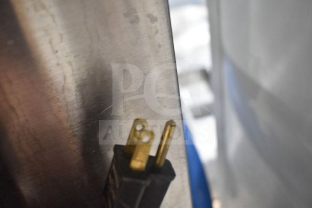 Close-up of a plug against a stainless steel surface, part of the Garland Master 200 convection oven.