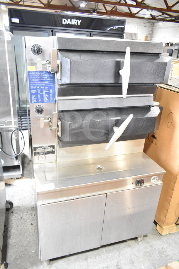 Cleveland electric double deck pressure steam cabinet, 480V, 3-phase, with control knobs and instruction labels, stainless steel.