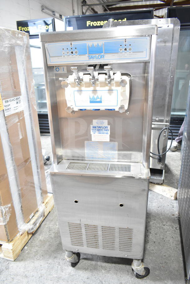 Taylor commercial water-cooled two-flavor soft serve ice cream machine with twist feature, on casters.