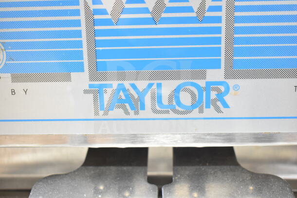 Taylor Commercial Water Cooled Soft Serve Ice Cream Machine label close-up, showing brand logo and design elements.