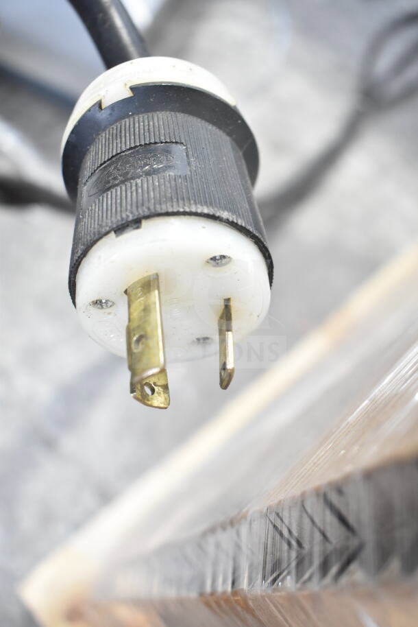 Close-up of an electrical plug from a Taylor Commercial Water Cooled 2 Flavor w/ Twist Soft Serve Ice Cream Machine.