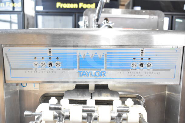 Taylor water-cooled, 2-flavor soft serve machine with twist function and commercial casters; control panel visible.