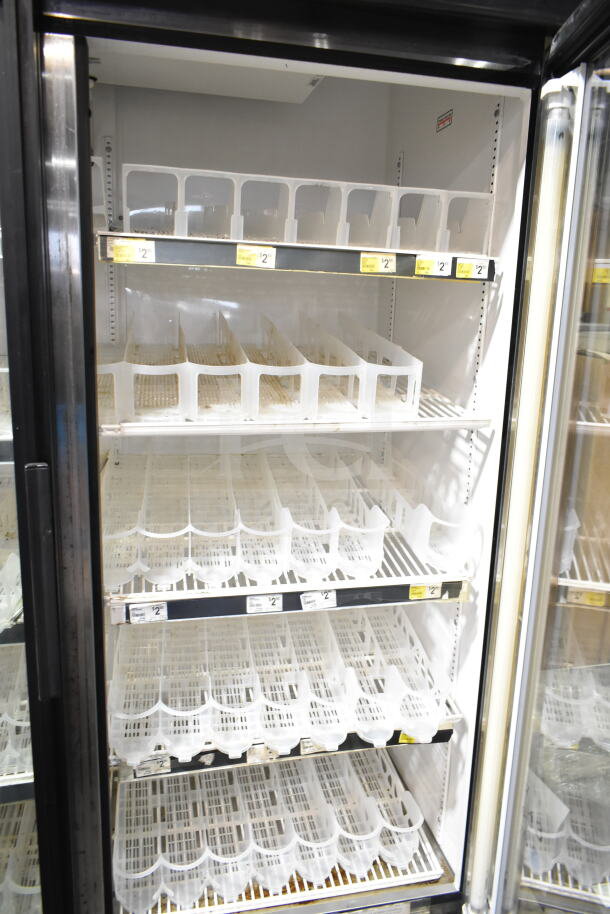 True Commercial 2 Door Reach-In Cooler Merchandiser, 115 volts, 1 phase, features multiple wire shelves, transparent plastic dividers, and pricing labels.