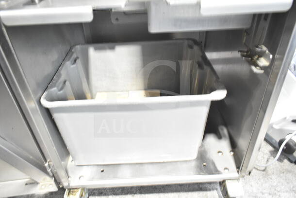 JBT 2ND-GEN-MFJ-HE citrus juicer interior view, missing back left caster, commercial floor style on casters, 115V.