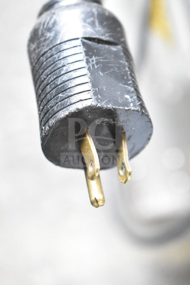 Close-up of a power plug for the JBT 2ND-GEN-MFJ-HE citrus juicer, 115 volts, 1 phase. Caster missing from back left.