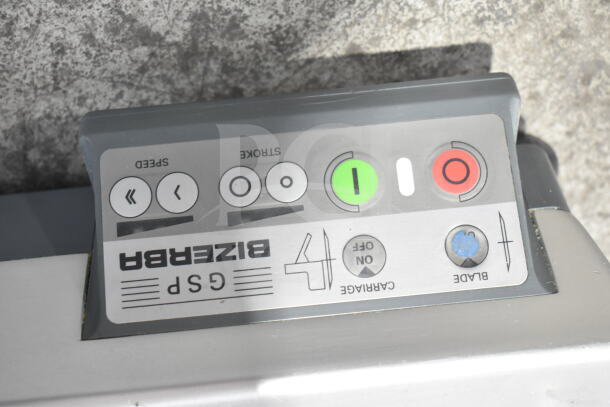 2017 Bizerba GSP HD meat slicer control panel with buttons for speed, stroke, and blade. Visible brand logo and function labels.