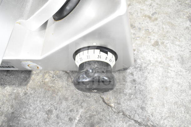 Bizerba SE 12 U meat slicer knob for thickness adjustment, showing markings from 0.5 to 24. Slicer in used condition.