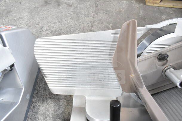 Bizerba SE 12 U commercial meat slicer, 120V, 1 Phase. Stainless steel, countertop model. Features blade guard and adjustment knob.