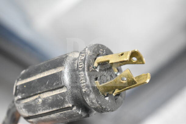 Close-up of a power plug for a True GDM-49F-HC freezer, showing prongs and condition.
