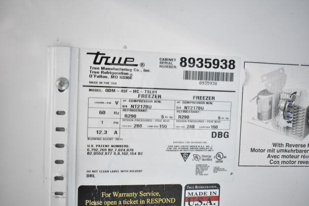 Label showing details of a True GDM-49F-HC freezer, model, voltage, refrigerant, and patent numbers. Made in USA.