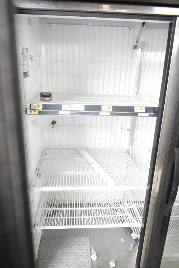 2016 True GDM-49F-HC commercial 2-door reach-in freezer, white interior, model label visible, empty shelves.