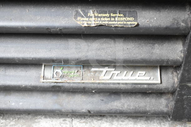 2016 True GDM-49F-HC freezer merchandiser tag showing brand logo and "natural refrigerant" label.