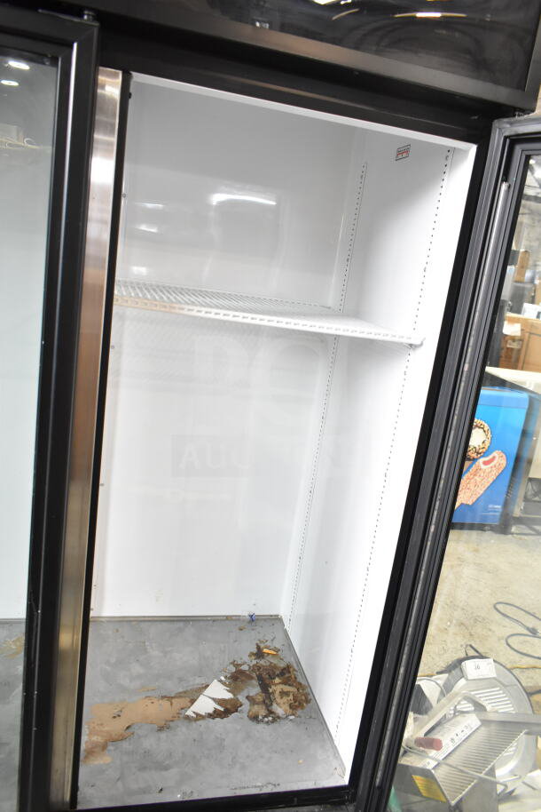 2019 True GDM-72-HC commercial 3-door reach-in cooler. Visible interior shelf, signs of wear on the base. 115 volts, 1 phase.
