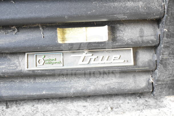 2019 True GDM-72-HC commercial cooler with "True" logo, natural refrigerant label, showing wear. 115V, 1 phase power.