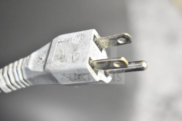 Close-up of a plug for a 2017 Bizerba GSP H commercial meat slicer, 120 volts, showing prongs and markings.