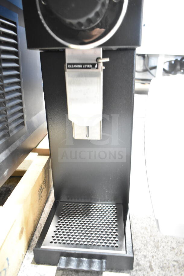 Bunn G3 HD black bulk coffee grinder, cleaning lever visible, sturdy metal base, commercial-grade condition.
