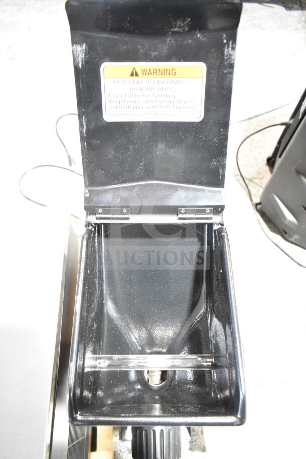 Bunn G3 HD black bulk coffee grinder, 3 lb. capacity, shows open hopper with warning label, in good condition.