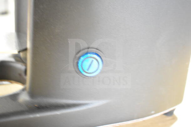 Nuova Simonelli G60OD espresso grinder, black finish, showing blue adjustment knob on side. Model: G60OD, 110V, 1 lb. capacity.