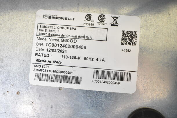 Nuova Simonelli G60OD espresso grinder label showing model, serial number, voltage, made in Italy.
