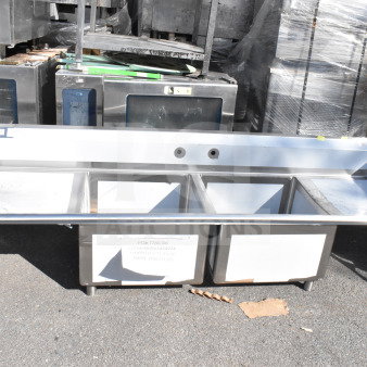 Alt text: "Regency 600S22424224 commercial 2 bay sink with dual drain boards, scratch and dent, new condition, visible labels."