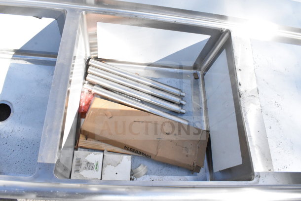 BRAND NEW Regency 600S22424224 Commercial 2 Bay Sink with Dual Drain Boards, visible packaging and components, minor scratches.