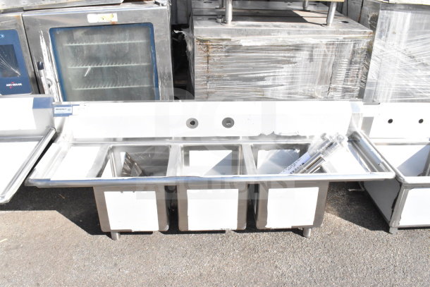 Regency 600S31416212 3-bay sink with dual drain boards, brand new with scratches and dents. Stainless steel, commercial use.