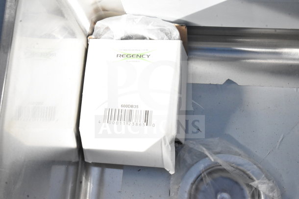Regency 600S31416212 commercial 3 bay sink with dual drain boards, brand new, showing box label and part inside sink.
