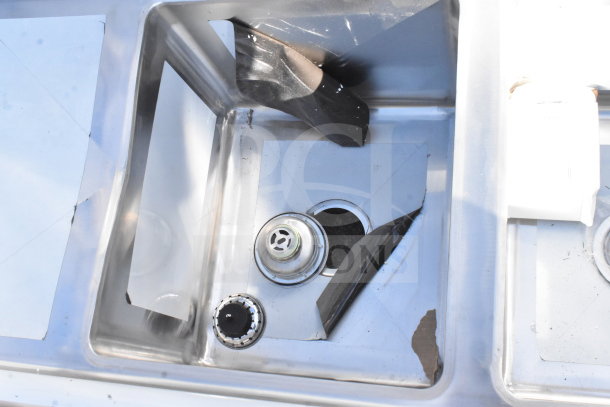 BRAND NEW Regency 600S31416212 commercial 3 bay sink with scratches and dents, dual drain boards visible.