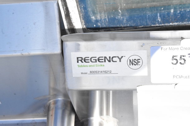 BRAND NEW Regency 600S31416212 Commercial 3 Bay Sink with dual drain boards, visible NSF label. Scratch and dent condition.