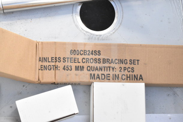 BRAND NEW Regency 600S32424224 Commercial 3-Bay Sink with dual drain boards, visible scratch, with stainless steel cross-bracing set in packaging.