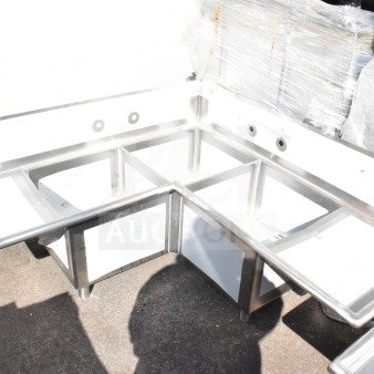 Brand new Regency 600S32020C commercial L-shaped sink with 3 bays, dual drain boards, and no legs. Scratch and dent.