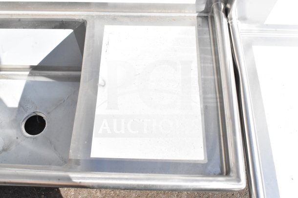 Brand new Regency 600S32020C commercial 3-bay L-shaped sink. Features dual drain boards, minor scratches, no legs.