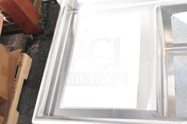 BRAND NEW Regency 600S32020C Commercial 3 Bay L Shaped Sink, dual drain boards, scratch and dent, no legs visible.