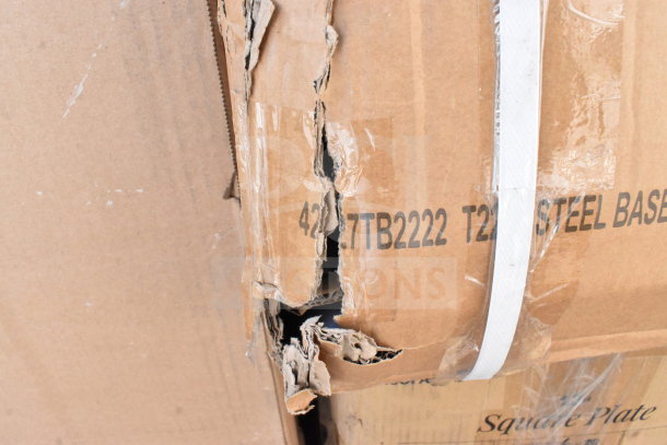Cardboard box with torn edges, showing "TB2222 T2 STEEL BASE" marking, indicating contents of scratch and dent items.