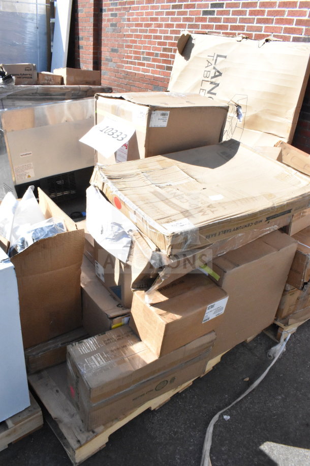 Stack of 12 scratch and dent items on pallets, including a juice dispenser and a motor, labeled with auction tag 10333.