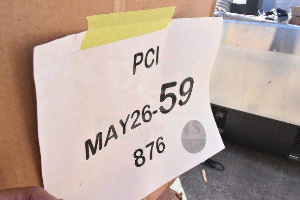 12 new scratch and dent items, including juice dispenser and motor, marked "MAY26-59" on cardboard.