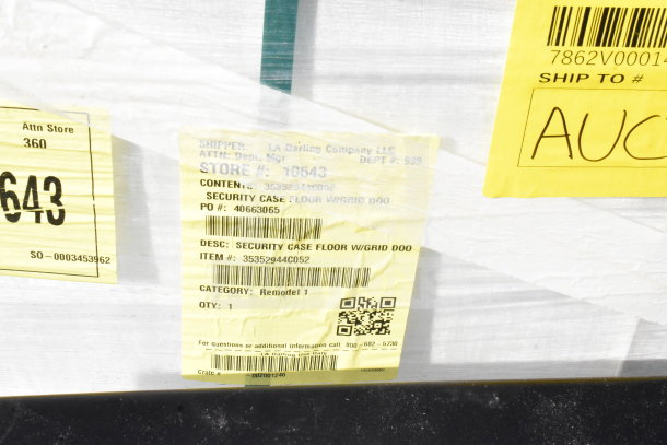 Alt text: "Brand new scratch and dent security case with floor grid, model 35352944C052, item and shipping labels visible."
