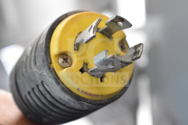 Close-up of a plug for the Hobart M-802 dough mixer. Yellow base, three prongs, marked with "L15-30P."