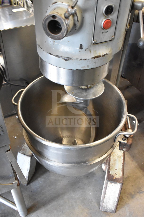 Hobart H 600 commercial dough mixer with 60-quart bowl and dough hook, 200V, floor style, visible wear, includes stop button.