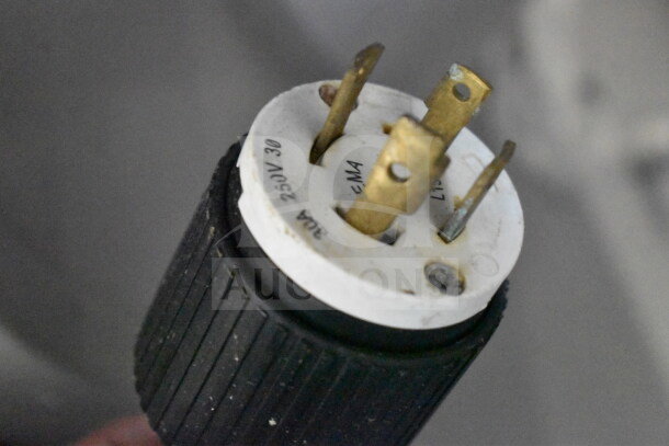 Close-up of a Mainca commercial sausage stuffer's plug, labeled 250V, 30A, single-phase, indicating electrical specs.