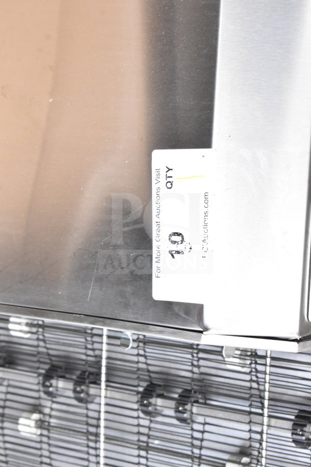 Alt Text: Hatco GRHD-4PD stainless steel merchandiser with slight scratches, dual shelf design, label showing auction info.
