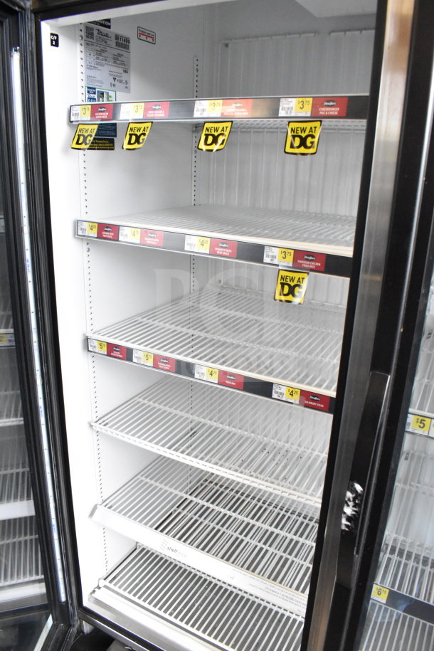 2019 True GDM-72F-HC commercial 3-door freezer, tested and working, showing interior shelves with DG sale tags.