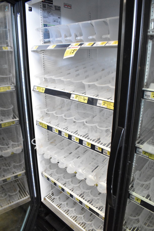 2019 True GDM-72-HC Commercial 3 Door Reach In Cooler. Tested, working, with price tags visible on empty shelves.